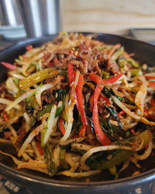 Bar Nohm signature dishes Sesame Noodles, Pork Omelette, Karaage, skewers including Chicken Hearts and Pork Belly-Wrapped Enoki Mushrooms.